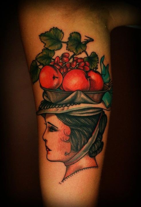 Woman with fruit basket tattoo by Charley Gerardin