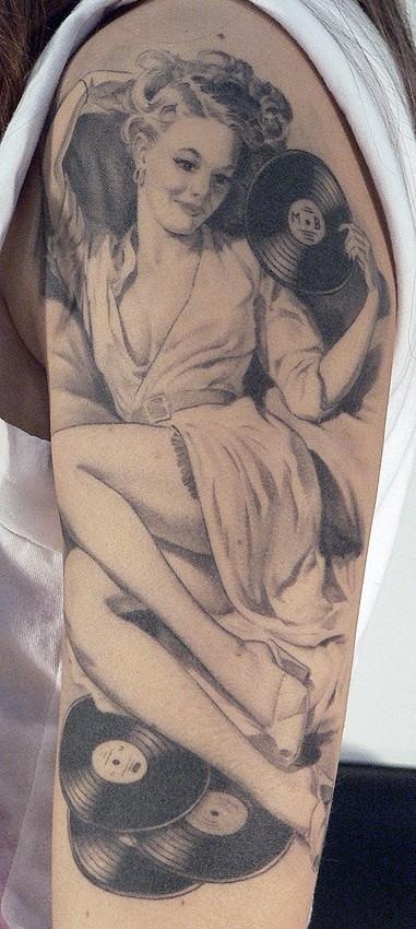 Woman with music records tattoo by Xavier Garcia Boix