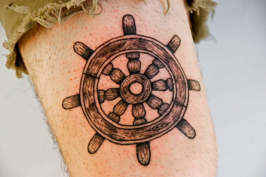 Wooden ship’s wheel tattoo