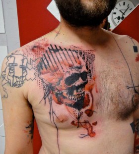 Xoil skull tattoo on chest