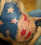 Torn American Flag on Shoulder Tattoo