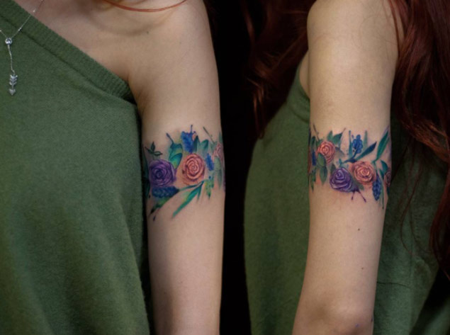 arm watercolor flower tattoo
