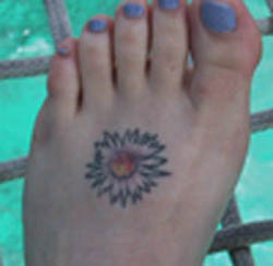 Cute Tiny Aster Flower Tattoo Design on Foot