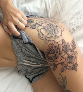 black and grey thigh flower tattoo