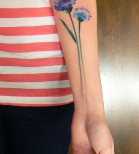 blue flower tattoo on arm