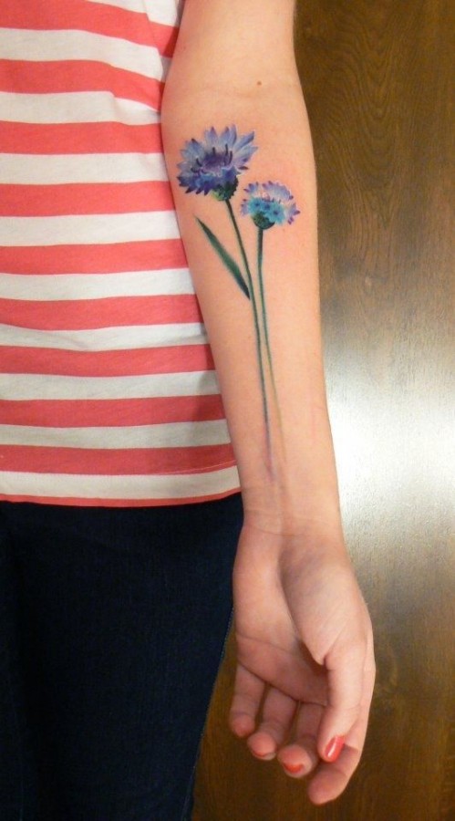 blue flower tattoo on arm