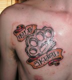 Brass Knuckles Tattoo on Chest