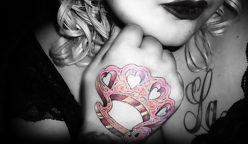 Pink Brass Knuckles With Sugar Skull Tattoo