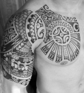chest and half sleeve tribal tattoo