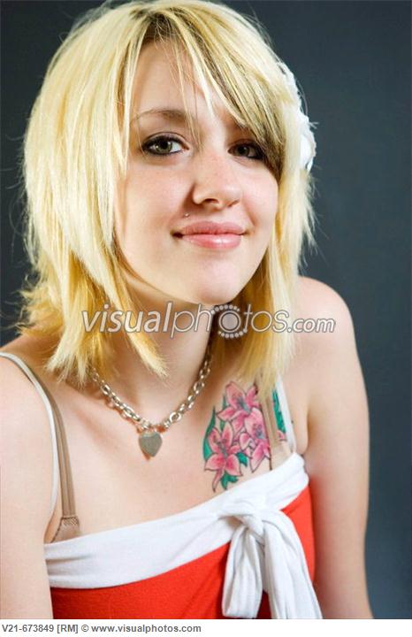 Woman With Tatoo On Chest And Face Piercing