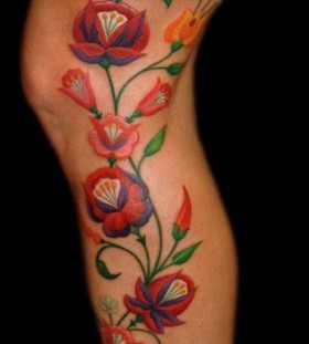 colorful flower tattoo on leg
