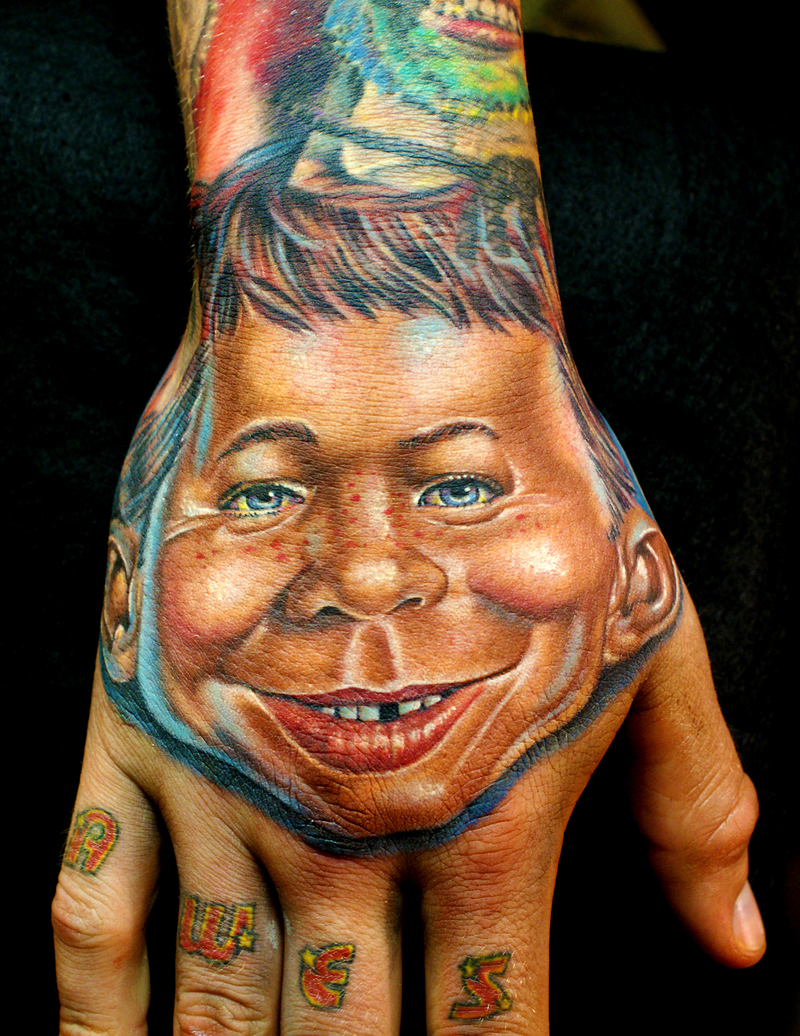 Awesome Face Tattoo on Upper Hand Idea for Guys