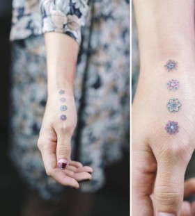 delicate hand flower tattoo