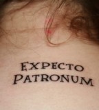Awesome Lettering Harry Potter Spell Expecto Patronum Tattoo on Women Upper Back