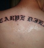 Artistic Font Of Latin Saying Tattoos On The Upper Back