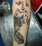 Gorgeous Arm Feather Into Birds Tattoo
