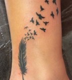 Black Feather into Birds Leg Tattoo