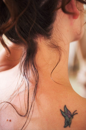 Feminine and Cute Small Butterfly Upper-Back Tattoo Designs for Women