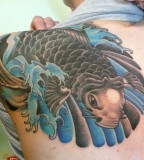 Awesome Flying Fish Tattoo On Upper Back