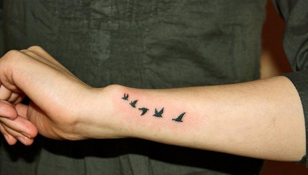 Beauteous Flying Birds Silhouettes Tattoo On Arm