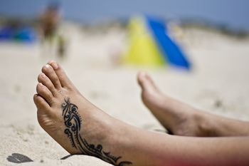 Bold Tribal Tattoo Design on Foot for men
