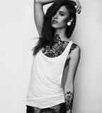 Girl With Tattoos In her Chest And Forearm