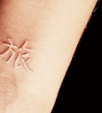 Japanese Letter On Forearm White Ink Tattoo