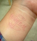Name On Wirst White Ink Tattoo