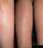 Curly Flower White Tattoo Design on Forearm