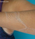 Symbolic White Ink Tattoo on Forearm