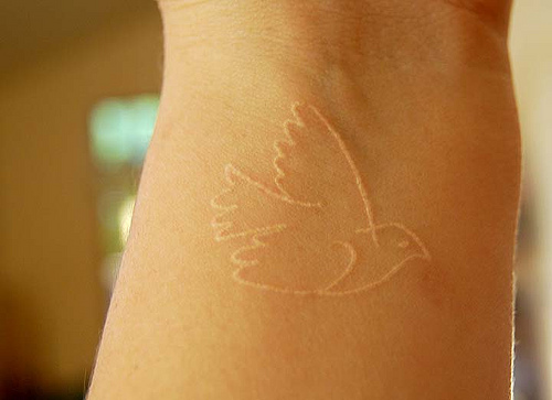 Cute Flying Bird White Ink Tattoo