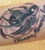 Swallow In Loving Memory Themed Tattoo Design on Forearm