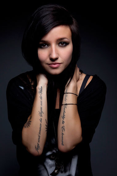 Girl Lights Poxleitner With Cursive Tattoo Lettering On Her Arms