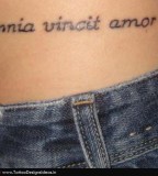 Design Of Latin Love Conquers All Tattoo On Hip