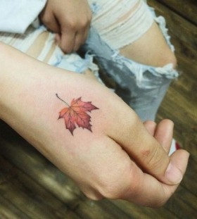 maple-leaf-on-hand-autumn-tattoo