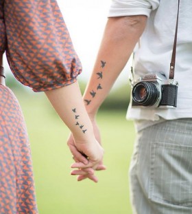 matching flying birds couples tattoos