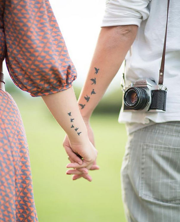matching flying birds couples tattoos