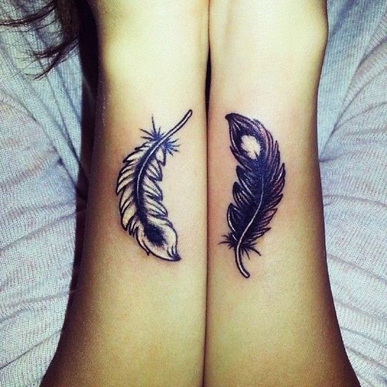 ying and yang feather tattoo