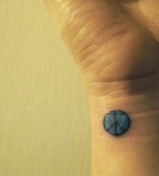 Tiny Peace Symbol Tattoo On Wrist