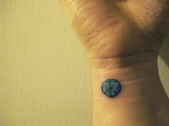Tiny Peace Symbol Tattoo On Wrist