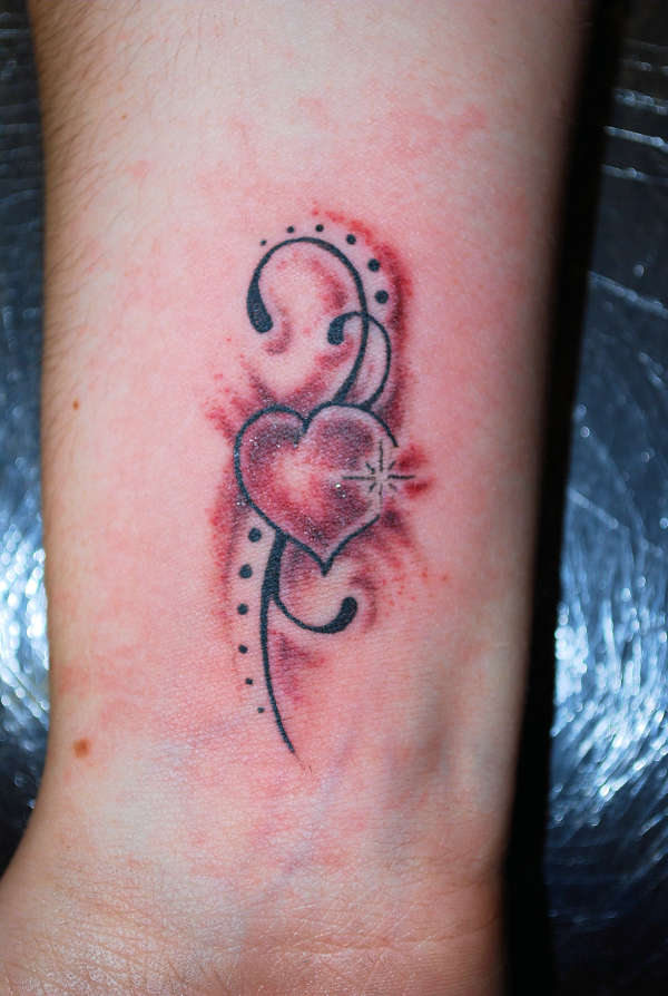 Tribal Bow And Heart Tattoos Images