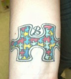 Colorful Puzzle Piece with B Initial Forearm Tattoo