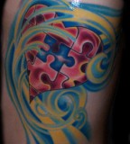 Gorgeous Colorful Puzzle Pieces with Swirly Design Tattoo Inspiration