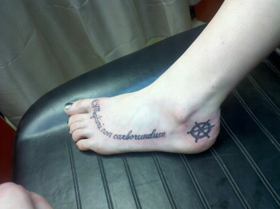 A Latin Quote Tattoo On The Foot In A Nice Cursive Font