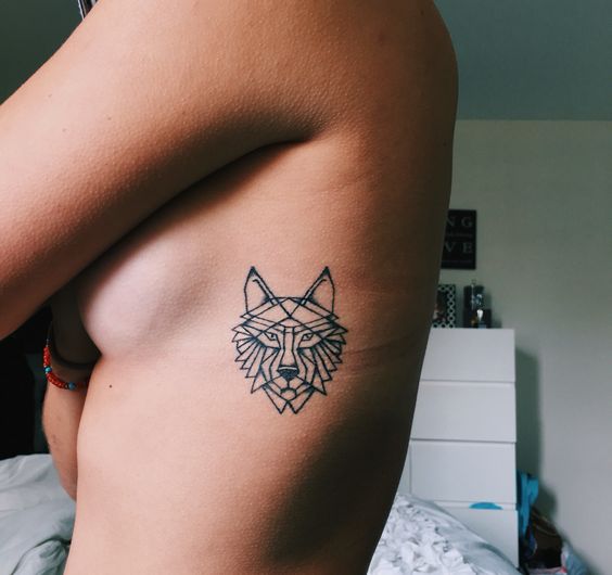 side-ribcage-geometric-wolf-tattoo