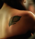 Upper Back Feather Tattoo For Girl