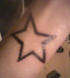 Large Black Star Tattoo On Girls Wrist