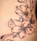 Flower And Swirls Tattoo On Ribs