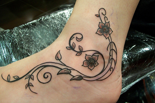 Awesome Swirly Flower Rod Tattoo on Ankle
