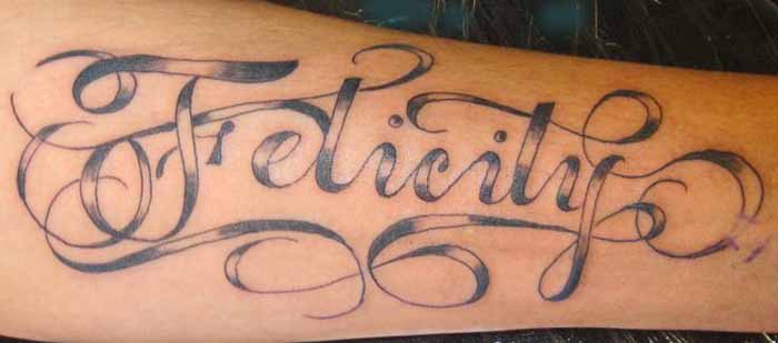 Felicity Name in Swirly Design Tattoo on Outer Lower Hand